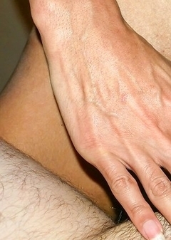 Ladyboy Nokyung is smiling on the bed in a netted pink dress. On her knees, she pulls her dress up to stroke her girl cock with some oil.